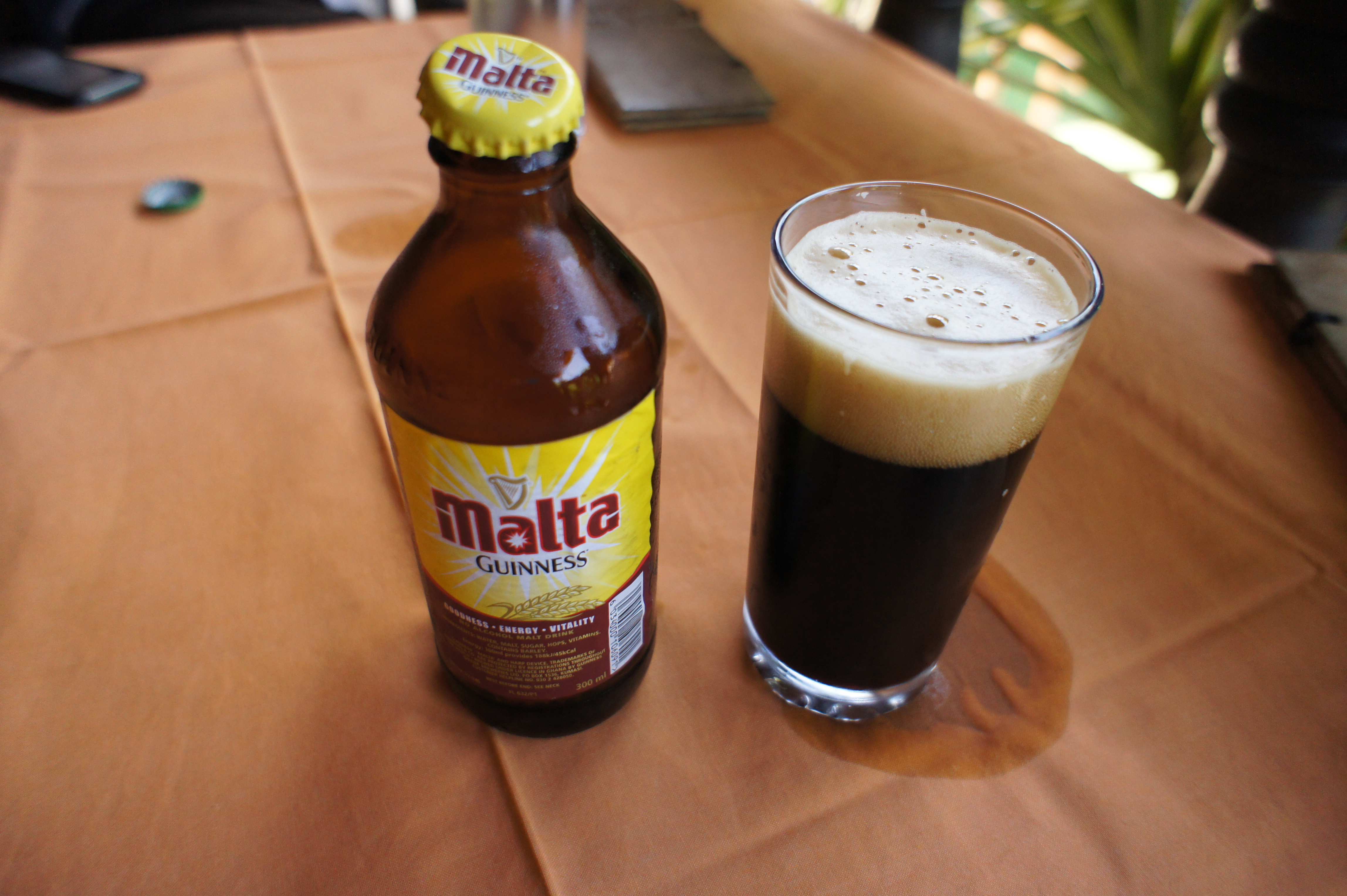 Malta Guinness bottle and a glass of malt drink